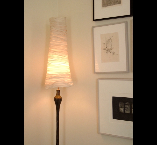 Tall and elegant Proud Woman II bronze floor lamp with layered and draped muslin conical lampshade made by sculptress Hannah Woodhouse. 